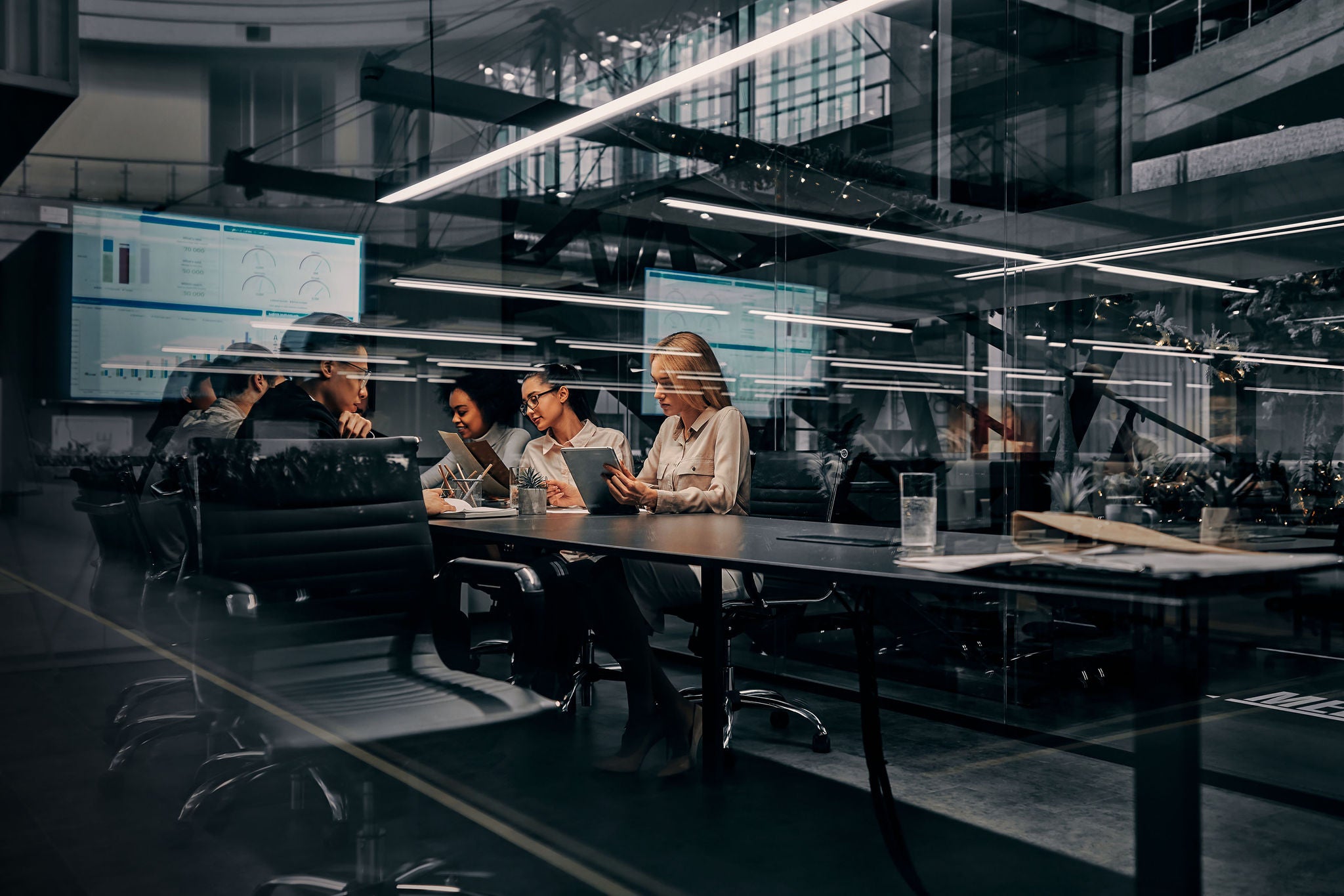 business women and men working in a conference room working on a project presentation 