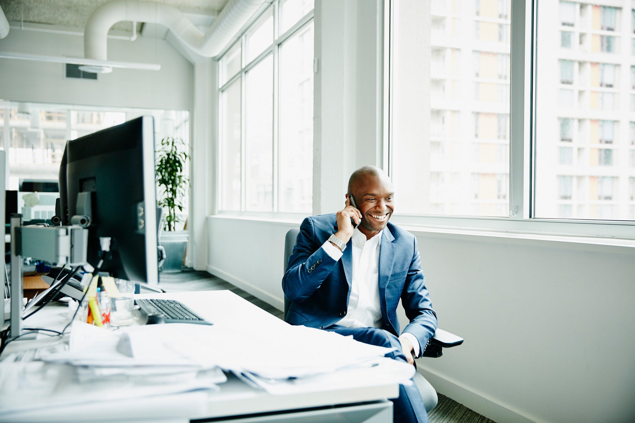 Young man smiling and chatting over phone