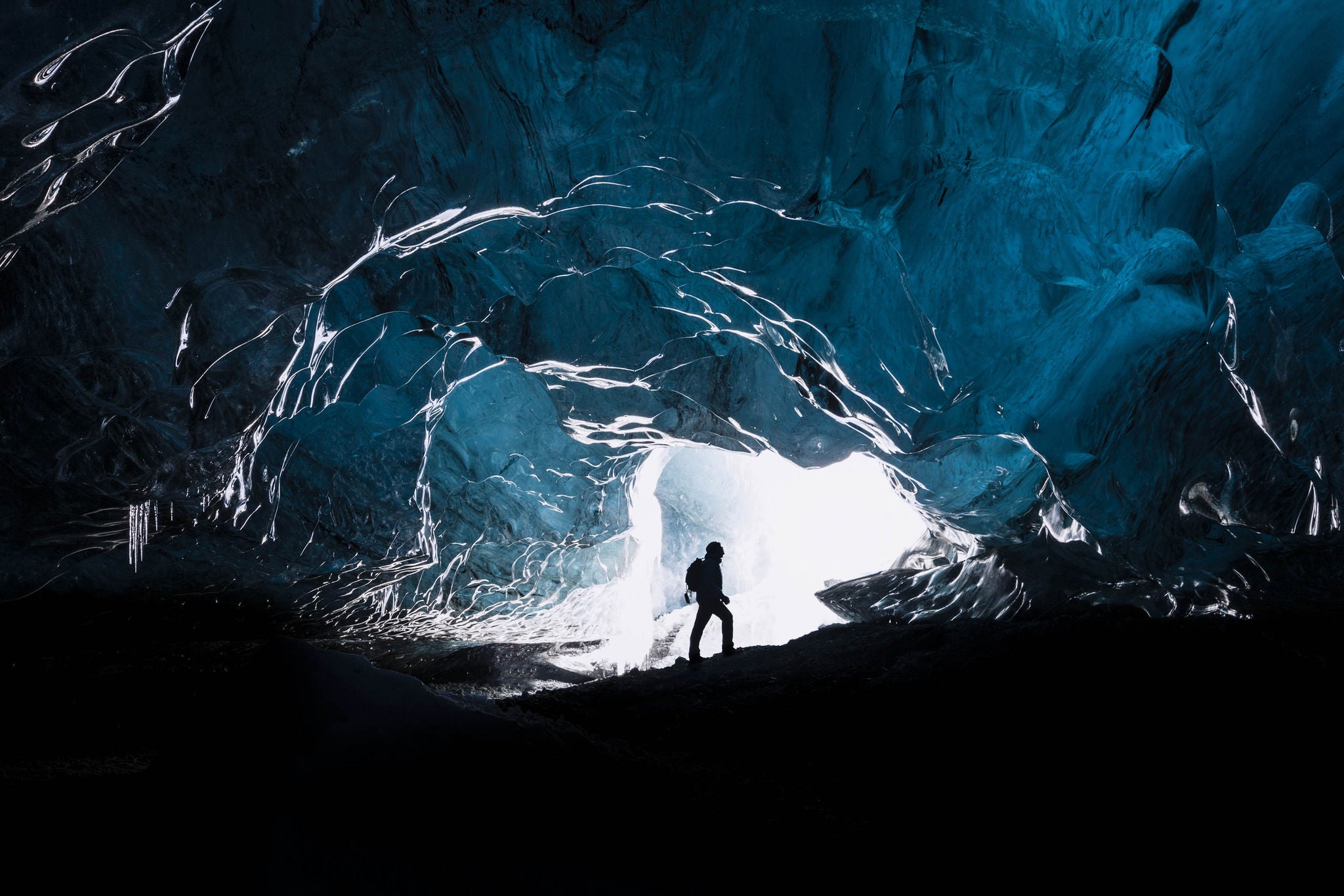 Man exploring an amazing glacial cave in Iceland