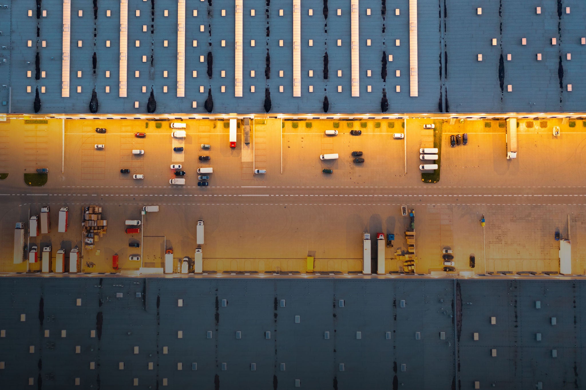 Aerial view of cars waiting to be unloaded at the logistics warehouse