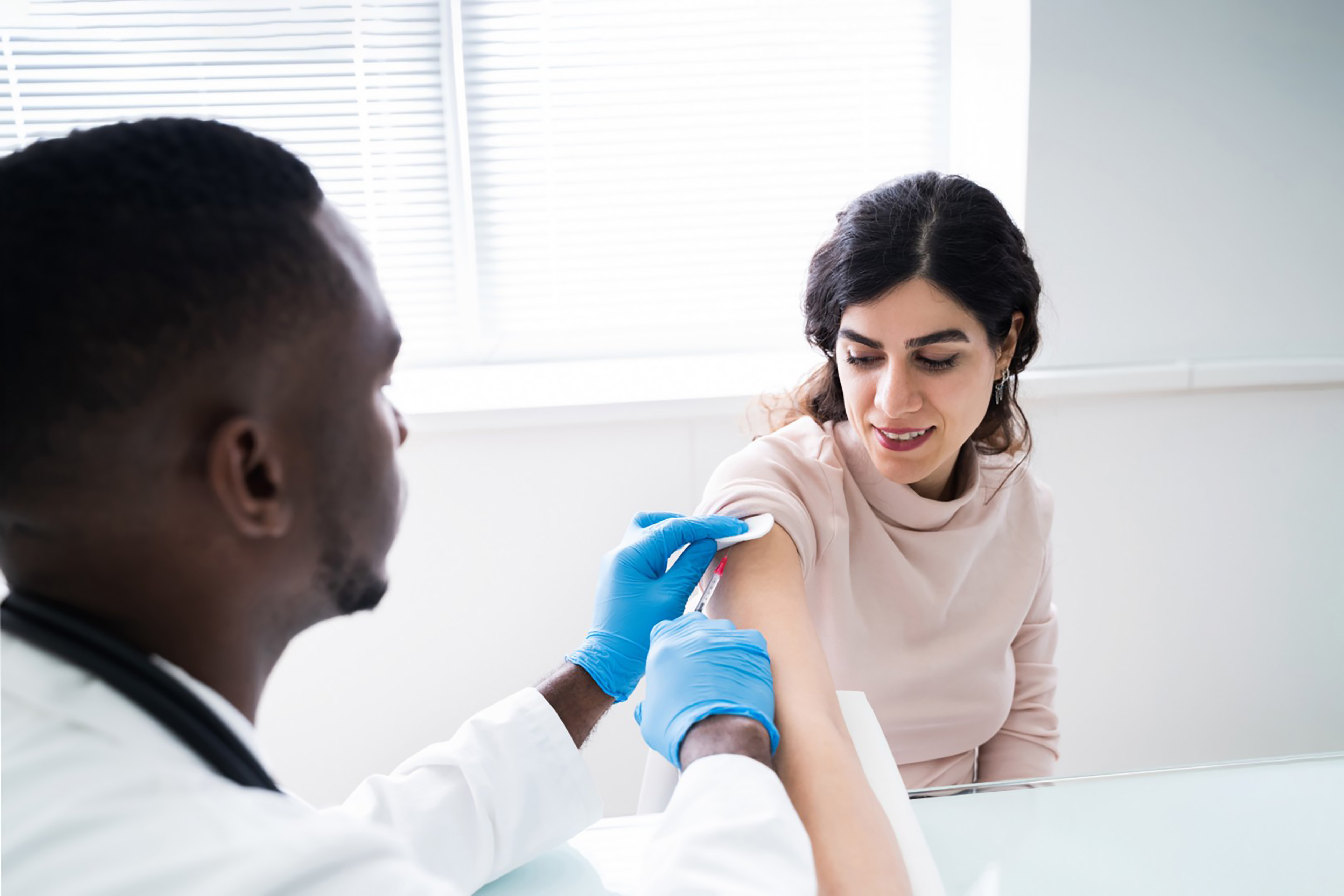 Doctor injecting into a patient