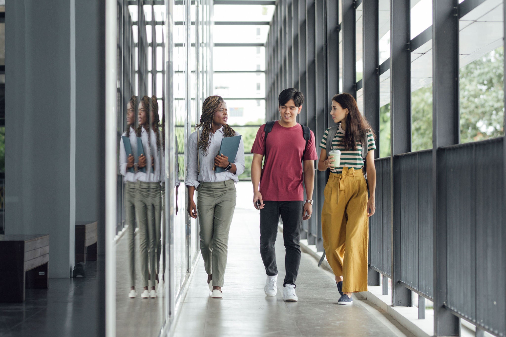 Group of students walking together and chatting on campus