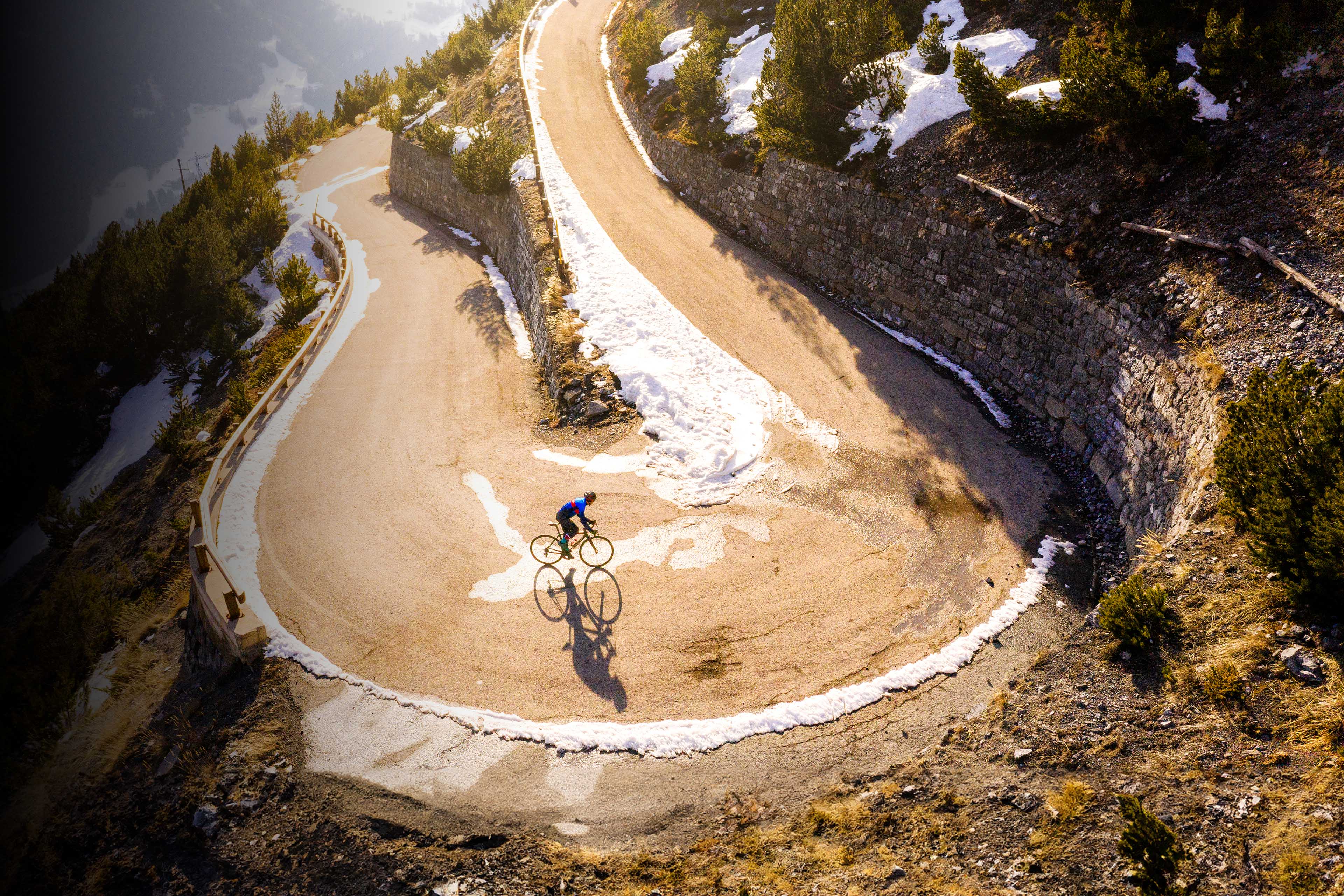 Road cyclist riding through hairpin