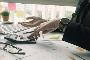 Professional using calculator in office photo