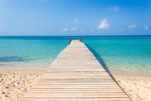 Wooden bridge on a tropical beach photo