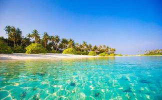 Beautiful blue water at a tropical beach photo