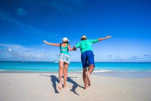 Couple running towards the ocean photo