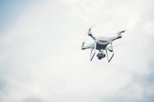 Flying drone with blue sky background photo