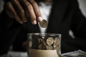 Businessman gIving money donation to charity photo