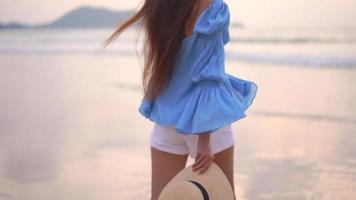 Woman Walks Around Beach Sea Ocean at Sunset video