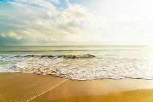 Beautiful and empty beach sea at sunrise or sunset time photo