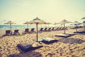 Umbrella and chair on the beach and sea photo