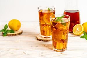 Glass of ice lemon tea with mint photo