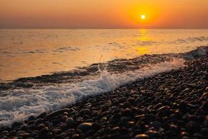 Sunset at sea. Beautiful sunset on the beach and sea photo