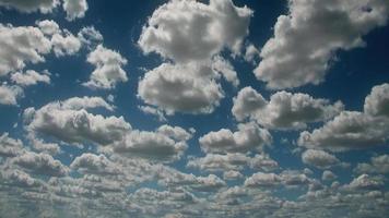 Time lapse clouds travel across a blue sky. video