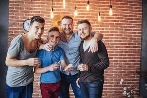 Cheerful old friends communicate with each other  glasses of whiskey in pub. Concept  entertainment and lifestyle photo