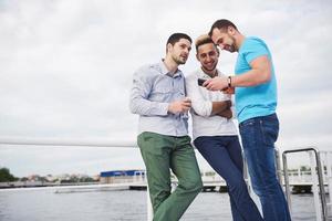 A group of young and happy men on the pier. photo