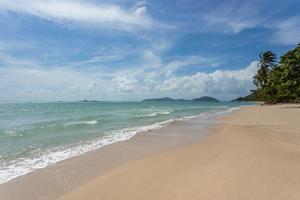 Sea view from tropical beach with sunny sky. Summer paradise beach of Koh Samui island. Tropical shore. Tropical sea in Thailand. Exotic summer beach with clouds on horizon. photo