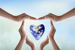 Earth conservation concept. human hand heart protect the earth nature blur background photo