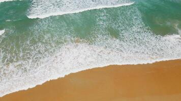 Aerial view of sand beach and water surface texture. Foamy waves with sky. Beautiful tropical beach. Amazing Sandy coastline with white sea waves. Nature, seascape and summer concept. video