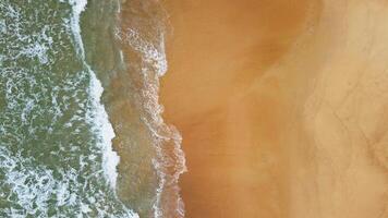 Aerial view of white sand beach and water surface texture. Foamy waves with sky. Beautiful tropical beach. Amazing Sandy coastline with white sea waves. Nature, seascape and summer concept. video