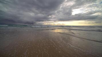 Blue ocean sand beach and water surface texture. Foamy waves with sky. Beautiful tropical beach. Amazing Sandy coastline with white sea waves. Nature, seascape and summer concept. video