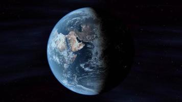 Planet Earth in space rotates from day into night as city lights turn on - Loop video