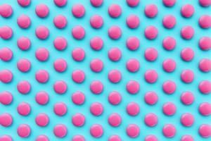 Pink coated chocolate candies scattered on blue background. repetition Seamless pattern 3d illustration photo