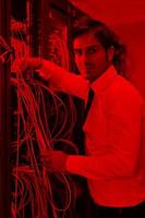 young it engineer in datacenter server room photo