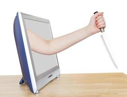 female hand with large kitchen knife leans out TV photo