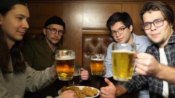 Young friends having fun together drinking beer in a pub. photo