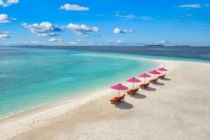 Amazing tranquil sea sand sky. Recreational summer travel tourism. Aerial landscape view with chairs and umbrellas on paradise island beach, seaside. Resort vacation, exotic nature. Beautiful tropics photo