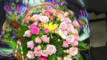 woman holding a basket with a bouquet of flowers video