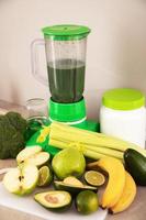 Blender, ingredients for healthy homemade smoothie on kitchen table photo