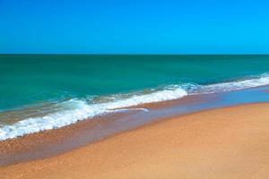 Sandy beach of seaside resort with clear water photo