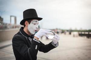 Mime on the street waiting to meet with his lover photo