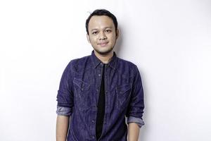 A portrait of a smiling Asian man dressed in a blue shirt, isolated by white background photo