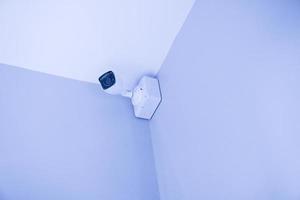 Security CCTV camera or surveillance system in building ,Closed-circuit television,Modern CCTV camera on a wall photo