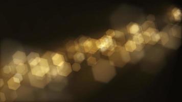 Defocused golden bokeh lights background. This elegant motion background animation with hexagonal lens blur bokeh particles is full HD and a seamless loop. video