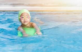 cute little girl learning how to swim photo