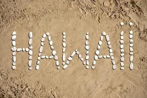 Hawaii - Word Made with Stones on Sand photo