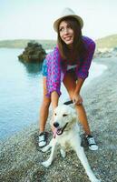 Woman with a dog on a walk on the beach photo