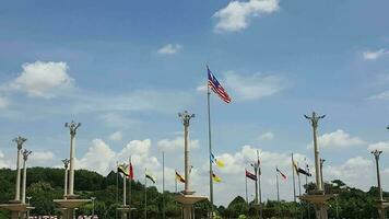 Several flagpoles with the Malaysian flag attached to them. The flag flutters in the wind. Located in Dataran Putra Jaya in front of the Pink Putra Jaya Mosque video