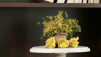 Mimosa flowers on a book shelf beside the window video