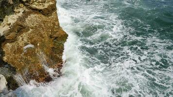 Sea waves wash over the rocks. Storm and bad weather at sea in super slow motion. video