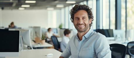 Smiling male software developer at work in office ample space photo