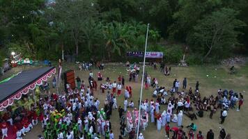 Gorontalo, Indonesia - August 17 2023  - Aerial view of Indonesian flag lowering ceremony witnessed by villagers. Indonesia Independence Day video