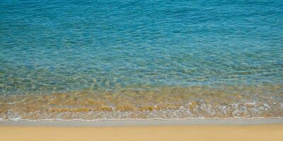 Clam and beautiful empty beach - amazing blue clear sea water and orange sand photo