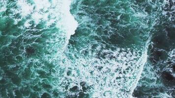 Aerial view of the Pacific Ocean waves hitting the cliff rocks. Top view of the waves. Sea shore during the storm. video