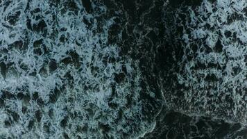 waves and foam in the ocean view from above, dark water video